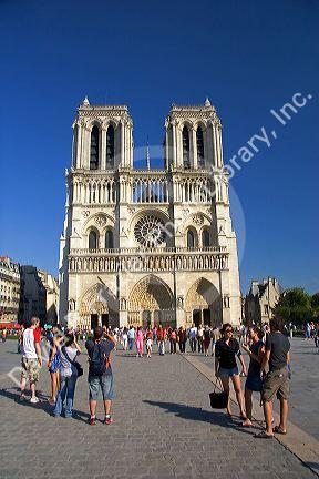 Visitors take photos of the Notre Dame cathedral in Paris, France.