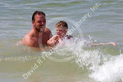 Father and son play in the water at St. Petersburg, Florida. MR