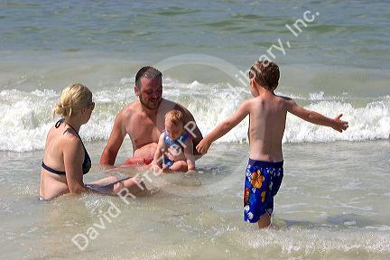 A family plays in the water at St. Petersburg, Florida. MR