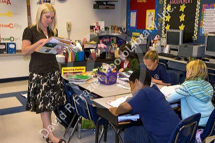 Teacher and fourth grade students in a classroom at a public school in Tampa, Florida.