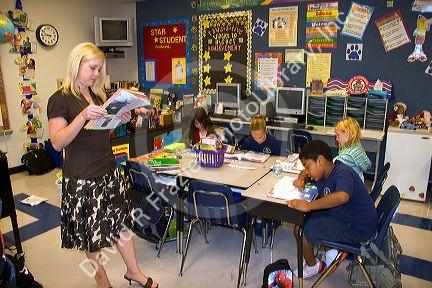 Teacher and fourth grade students in a classroom at a public school in Tampa, Florida.