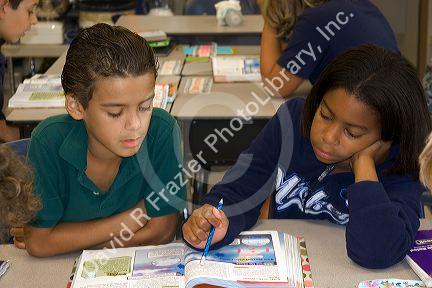 Fouth grade students read textbooks in a classroom at a public school in Tampa, Florida.