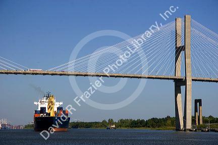 A container ship passes under the Talmadge Memorial Bridge at the Port of Savannah in Savannah, Georgia.