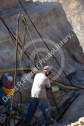 Worker drilling in a granite quarry in Elberton, Georgia.