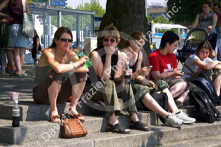 People sit on stone steps along Zurichsee at Zurich, Switzerland.switzerland, swiss, europe, european, travel, tourism, swiss alps, alps, alpine, zurich, steps, visitors, people, sit