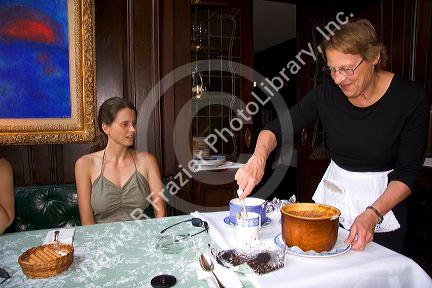 A server preparing desert at the Kronenhalle restaurant in Zurich, Switzerland.switzerland, swiss, europe, european, travel, tourism, swiss alps, alps, alpine, zurich, desert, server, waitress, prepare, kronenhalle, restaurant, painting, chagal, chagal painting, art