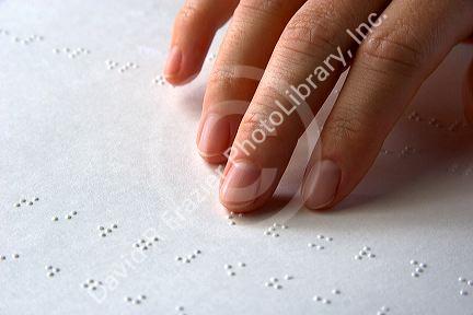 Hand reading braille.