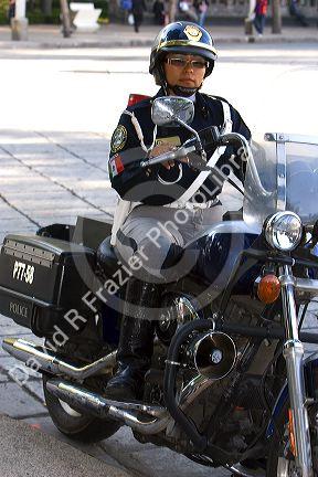 Female police officer riding a motorcycle in Mexico City, Mexico.