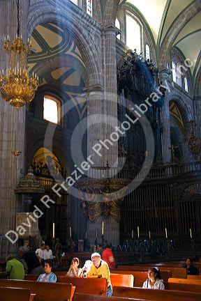 People pray in the Catedral Metropolitana located on the central square, the zocalo, Mexico.