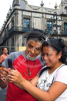 Mexican teens view photos taken with a cell phone in Mexico City, Mexico.