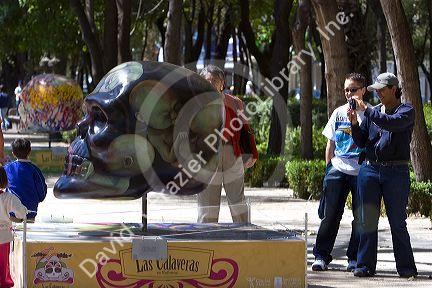 A painted skull is part of a public art display in celebration of the Day of Dead in Mexico City, Mexico.