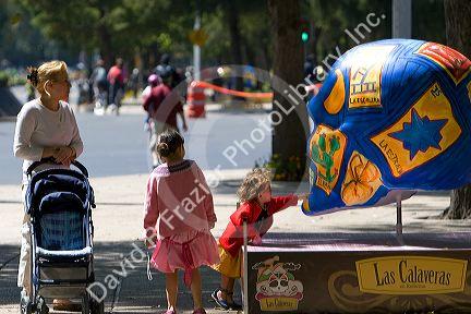 A large painted skull is part of a public art display in celebration of the Day of the Dead in Mexico City, Mexico.