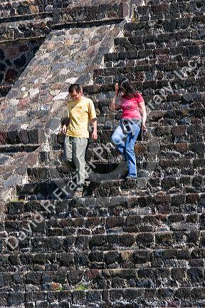 Tourists walk down the steps of the Pyramid of the Moon at Teotihuacan in the State of Mexico, Mexico.