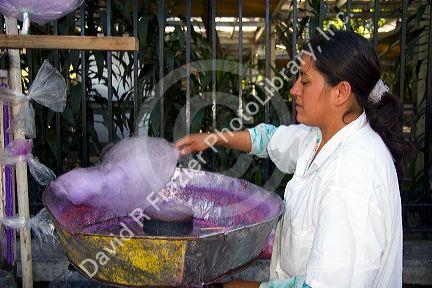 Mexican street vendor making cotton candy in Chapultepec Park in Mexico City, Mexico.