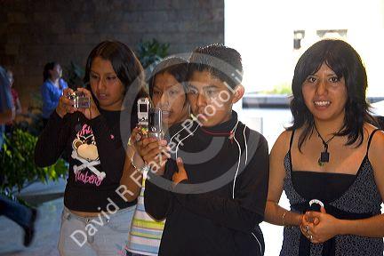 Mexican teens use cell phone cameras at the National Museum of Anthropology in Mexico City, Mexico.