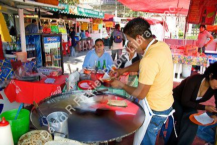 Food vendor making quesadillas in Mexico City, Mexico.