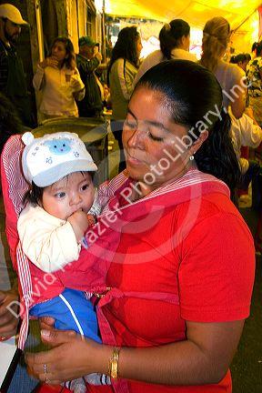 Mexican woman and infant child at the Merced Market in Mexico City, Mexico.