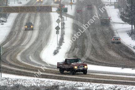 Automobiles driving on a snowy day in Boise, Idaho.