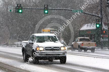 Automobiles driving on a snowy day in Boise, Idaho.