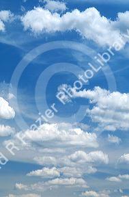 Cumulus clouds in a blue sky.