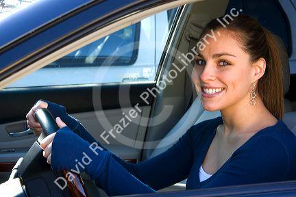 Young woman in the driver seat of a car. MR