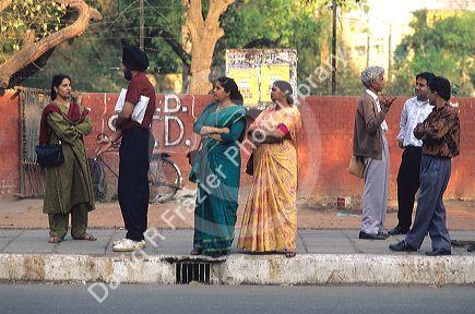 Indians waiting at a bus stop in Delhi, India.