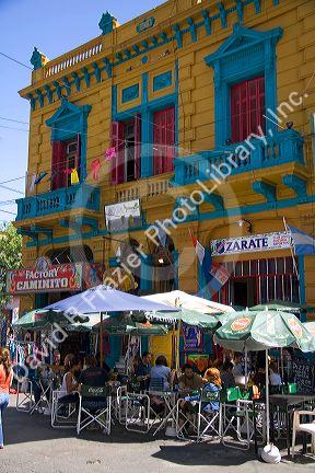People dine outdoors at a cafe in the La Boca barrio of Buenos Aires, Argentina.