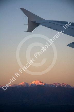 Aerial view of the Andes in Argentina at sunrise through the window of an airplane.