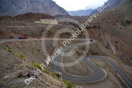 Vehicles drive on switchback roads in the Andes Mountain Range, Chile.