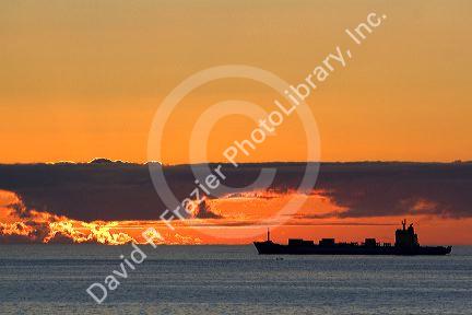 Container ship at sunset in the Pacific Ocean off the coast of Valparaiso, Chile.
