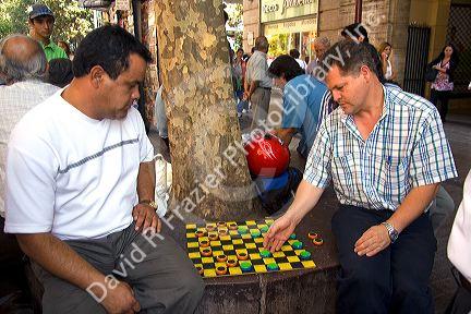 Chilean men play checkers in the Plaza de Armas in Santiago, Chile.