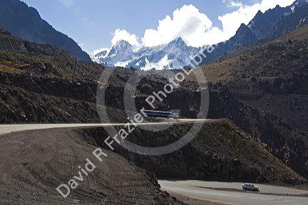 Vehicles drive on switchback roads in the Andes Mountain Range in Chile.