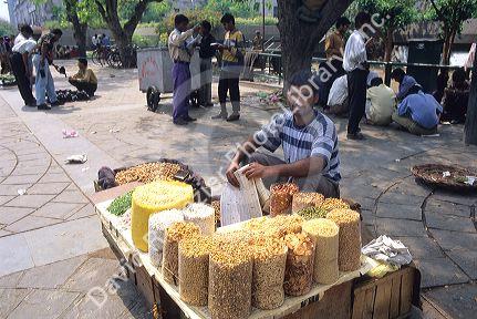 Street vendor selling food and snacks in India.