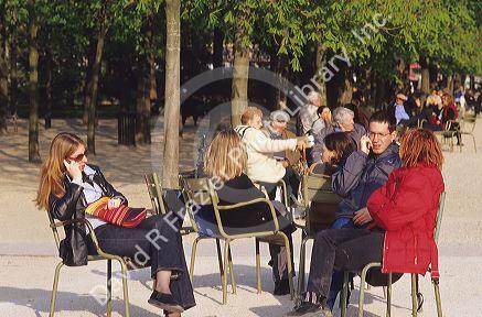 People talk on cell phones in Paris, France.