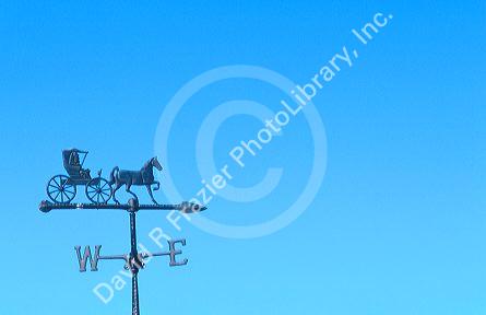 weathervane atop barn indicates wind direction.
