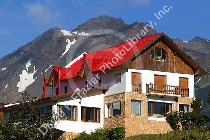 Chalet style house below the Martial mountain range at Ushuaia, Tierra del Fuego, Argentina.