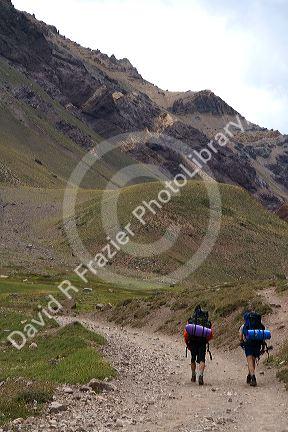 Hikers on a trail in the Andes Mountain Range, Argentina.
