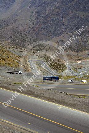 Vehicles drive on switchback roads in the Andes Mountain Range, Chile.