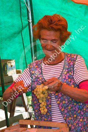 Woman selling produce at an outdoor market in Valparaiso, Chile.