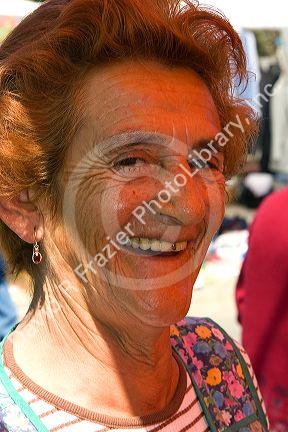 Portrait of an elderly woman working at an outdoor produce market in Valparaiso, Chile.