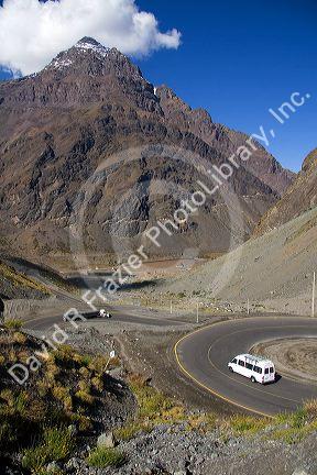 Trucks drive on switchback roads in the Andes Mountain Range in Chile.