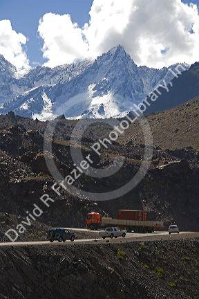 Vehicles drive on switchback roads in the Andes Mountain Range in Chile.