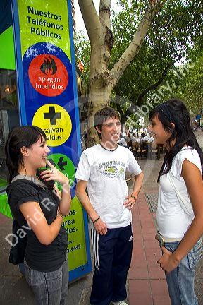 Chilean teens talk on the street in Mendoza, Argentina.