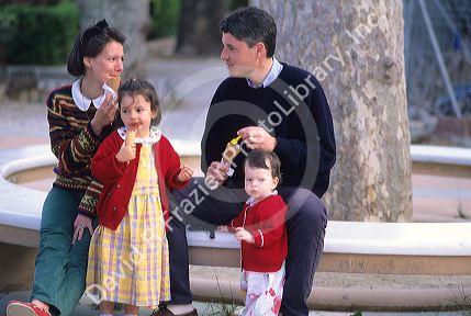 A french family eating ice cream in Paris, France.