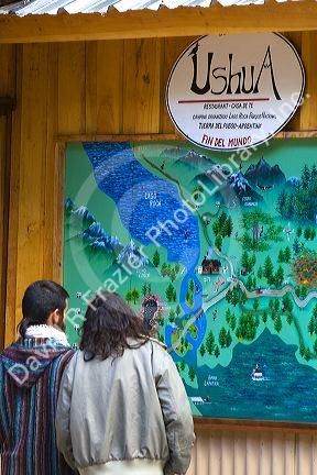 Tourists look at a map of the Tierra del Fuego National Park, Argentina.