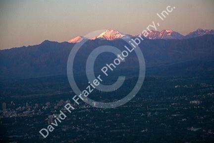 Aerial view of Mendoza and the Andes in Argentina at sunrise through the window of an airplane.