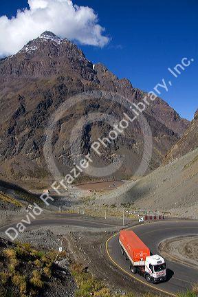 Trucks drive on switchback roads in the Andes Mountain Range in Chile.
