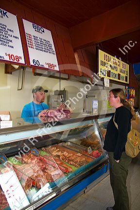 Woman shopping at a butcher shop in Boise, Idaho. MR