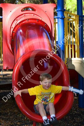 3 year old boy playing on playground equipment at a park in Tampa, Florida. MR