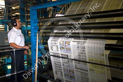 Newspaper being printed on a rotary printing press for the Houston Chronicle in Houston, Texas.
